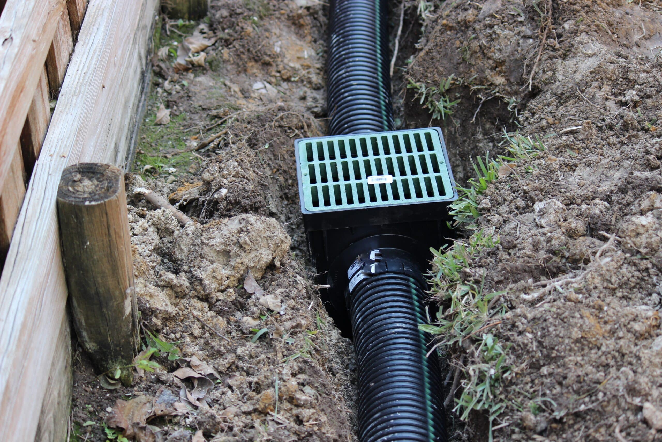 Building an Underground French Drain System after Digging the trench system to keep water away from home's foundation.