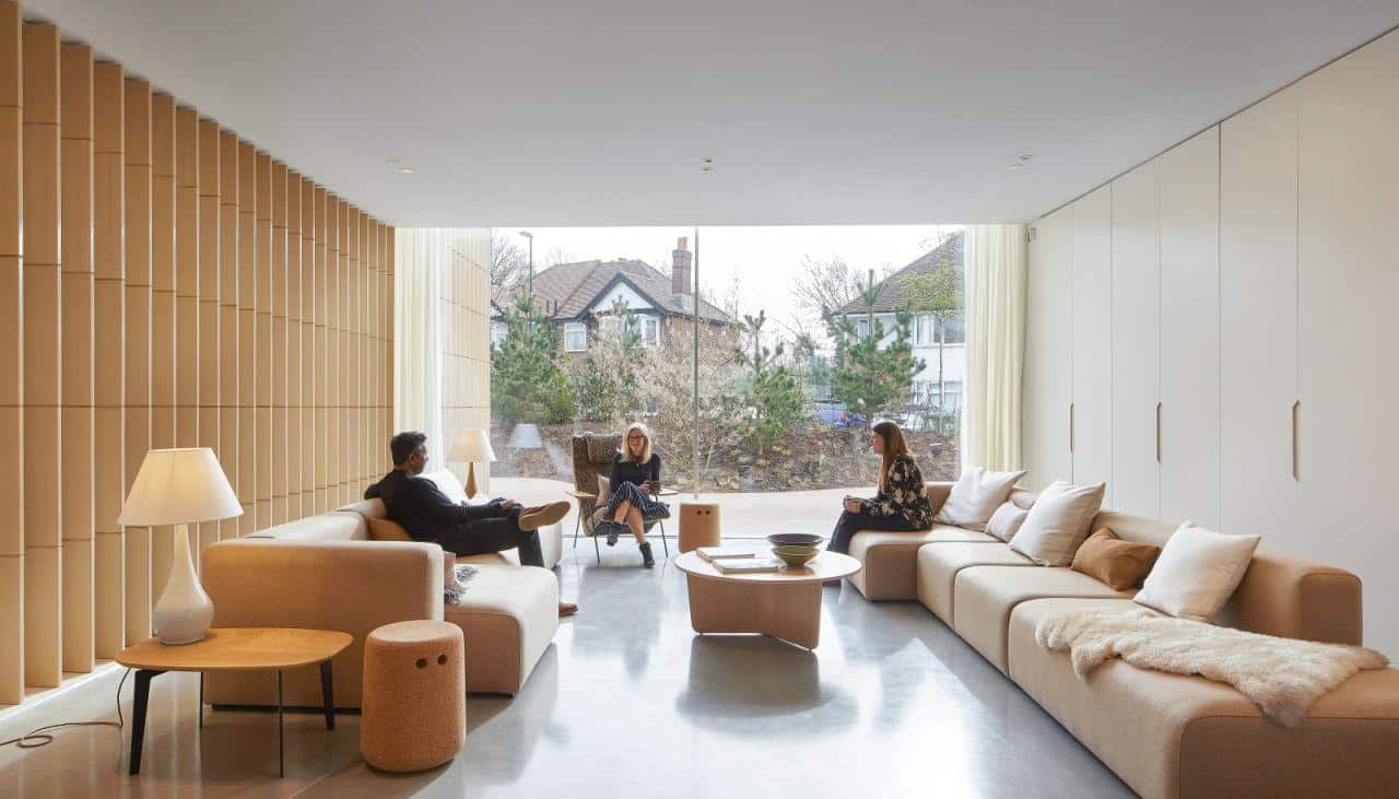 A seating area with floor-to-ceiling glazing in the background.