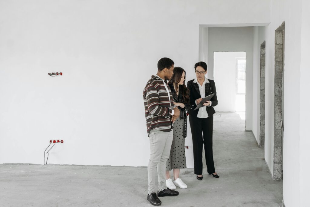A landlord talking to tenants in the newly renovated home