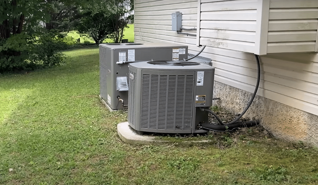 A couple of air conditioning units outside of a house AI-generated content may be incorrect.