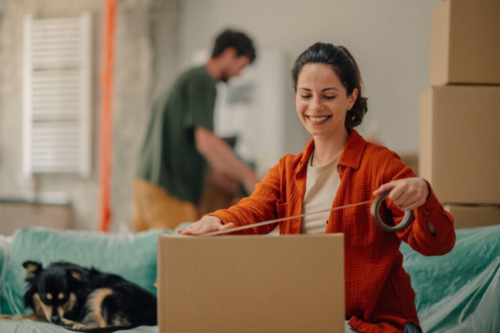 A woman packing with her spouse and dog, thinking to herself, “Can landlords charge for ESA?