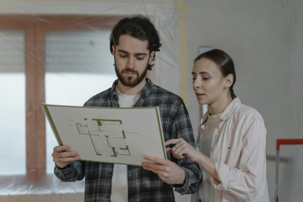 Two people reviewing a piece of paper