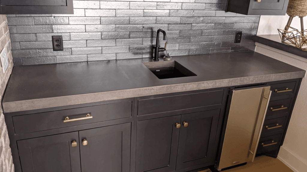 8. Black Cabinets with Concrete Countertops