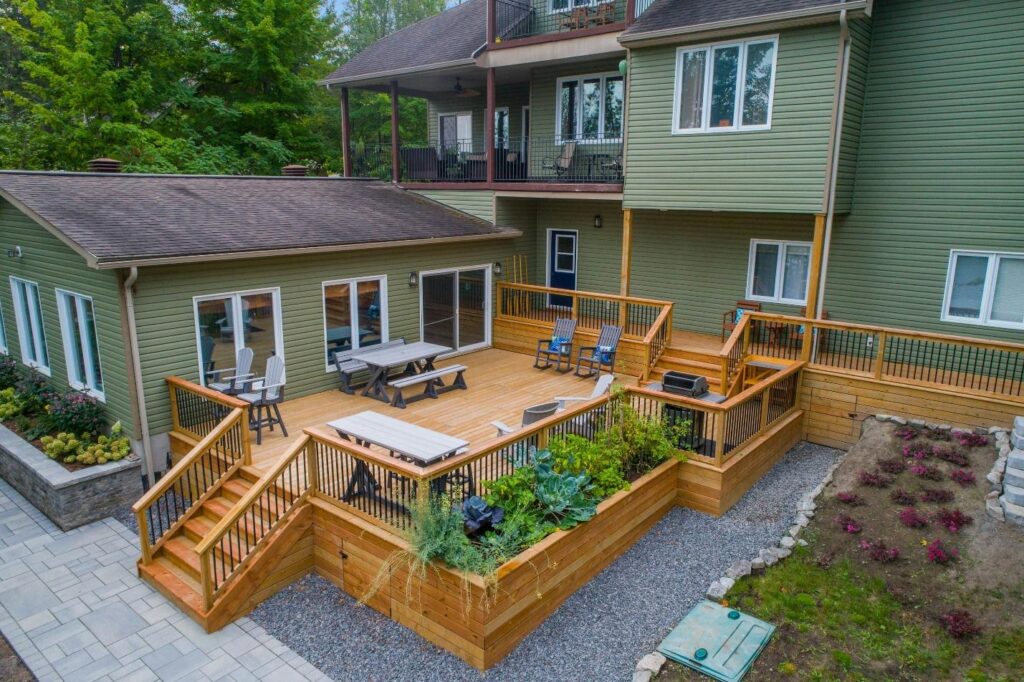 Diy Guide: How to Build a Backyard Deck Like a Pro a deck with chairs and tables on it and a deck with plants