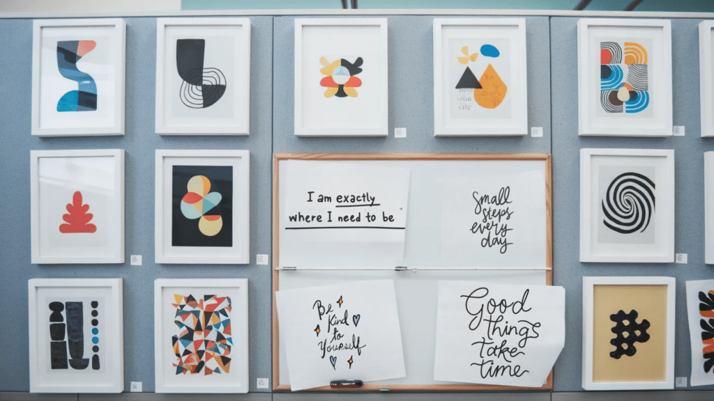 Art prints and motivational quotes on a cubicle wall