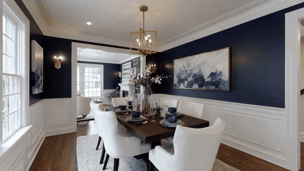 Dining room with deep navy walls and snowy white trim.