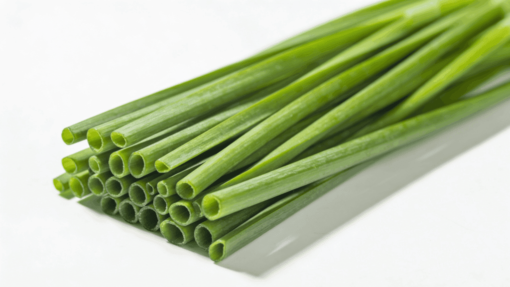 Fresh green chives arranged in a neat bundle on a white background.
