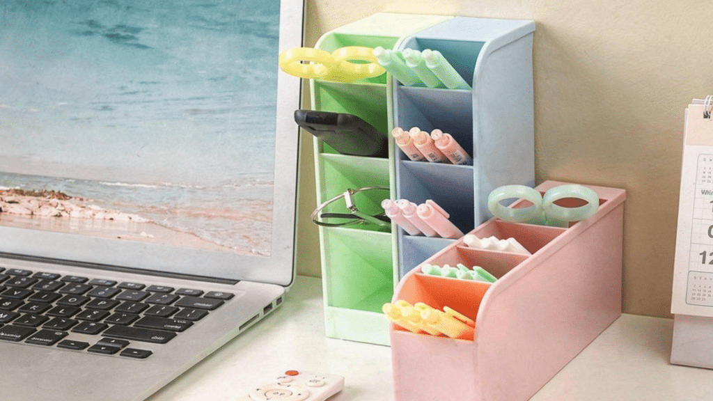 Matching pastel storage bins and trays on a cubicle desk