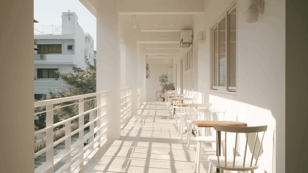 Narrow patio with furniture arranged along one side.