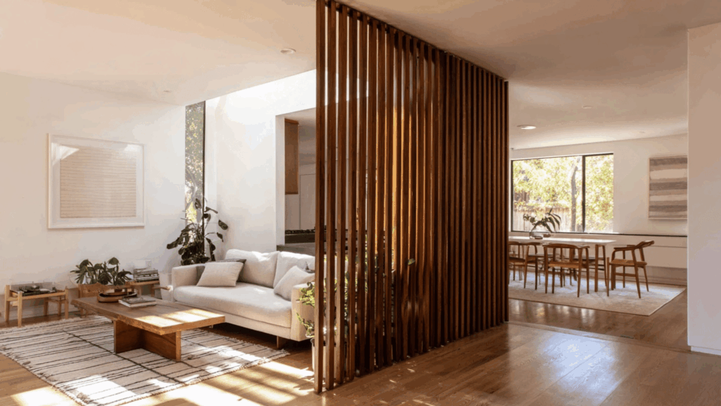 Wooden slat room divider in open mid century modern living space