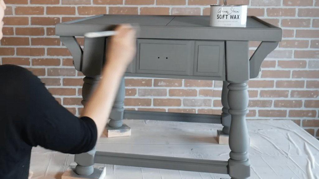 Applying clear wax over chalk-painted furniture for protection
