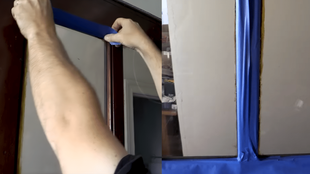 Masking the edges of the glass panel with painter’s tape to prevent overspray