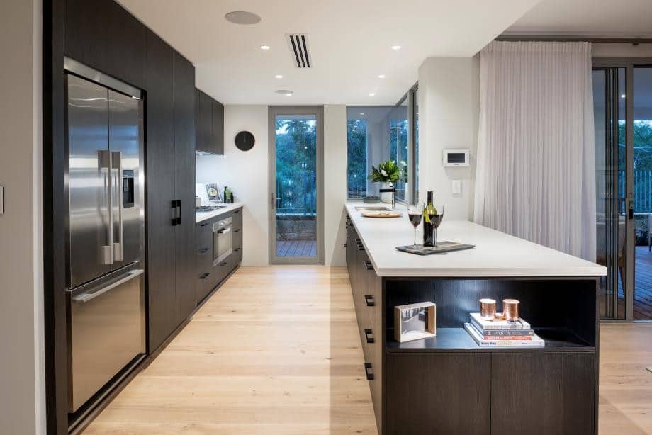 A kitchen with a white countertop and black cabinets AI-generated content may be incorrect.