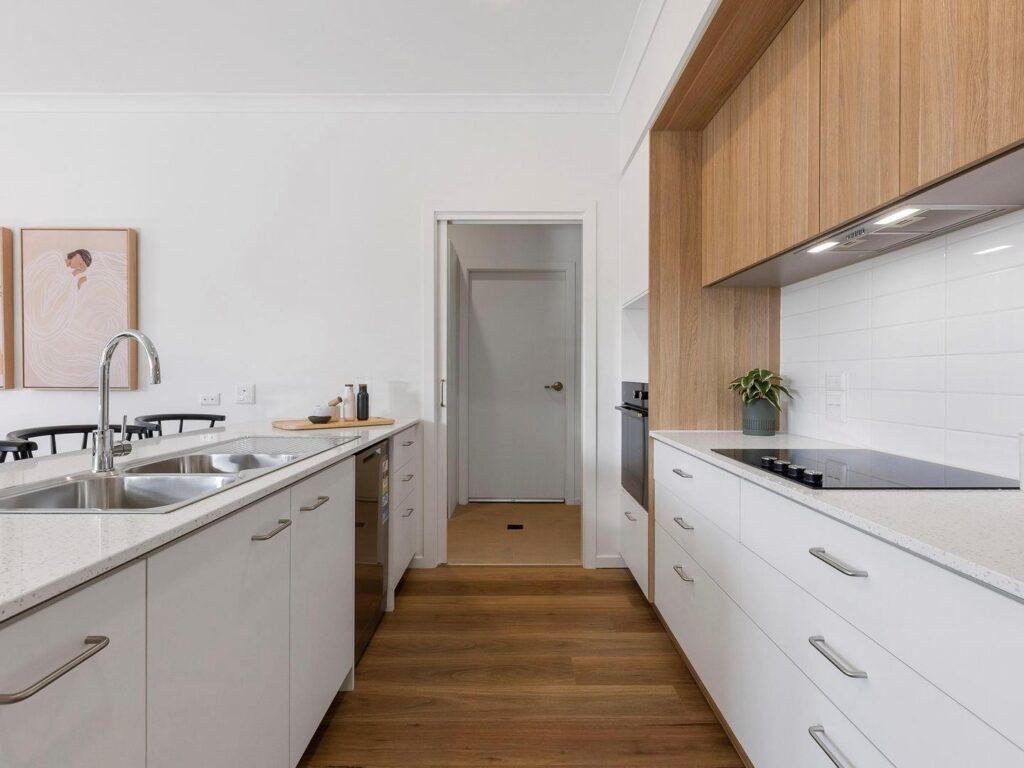 Best Kitchen Flooring Options A kitchen with white cabinets and wood floors AI-generated content may be incorrect.