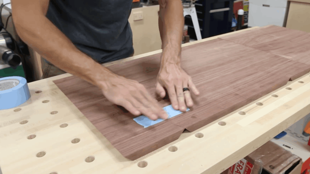 aligning wood panels and securing joints with tape for assembling table box structure