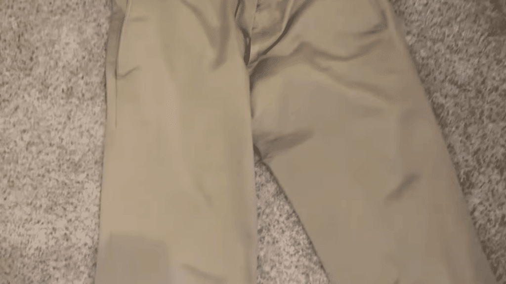 beige pants laid on carpet showing cleaned fabric surface after treatment demonstrating how to remove mold from fabric results