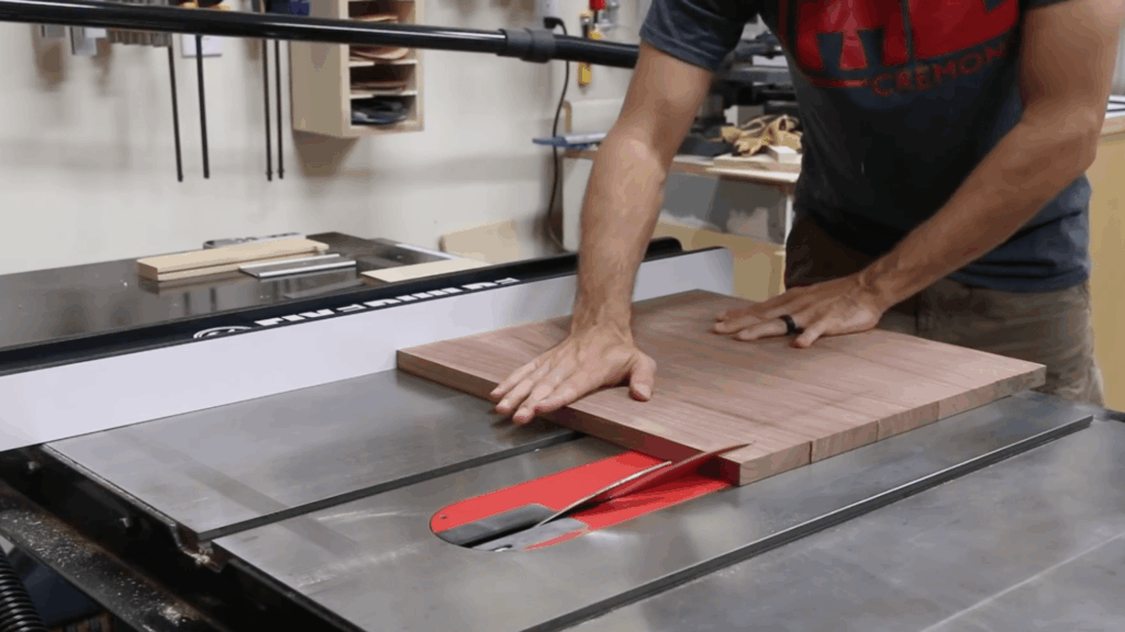 cutting angled edges on wood panel using table saw for clean corner joints in table build