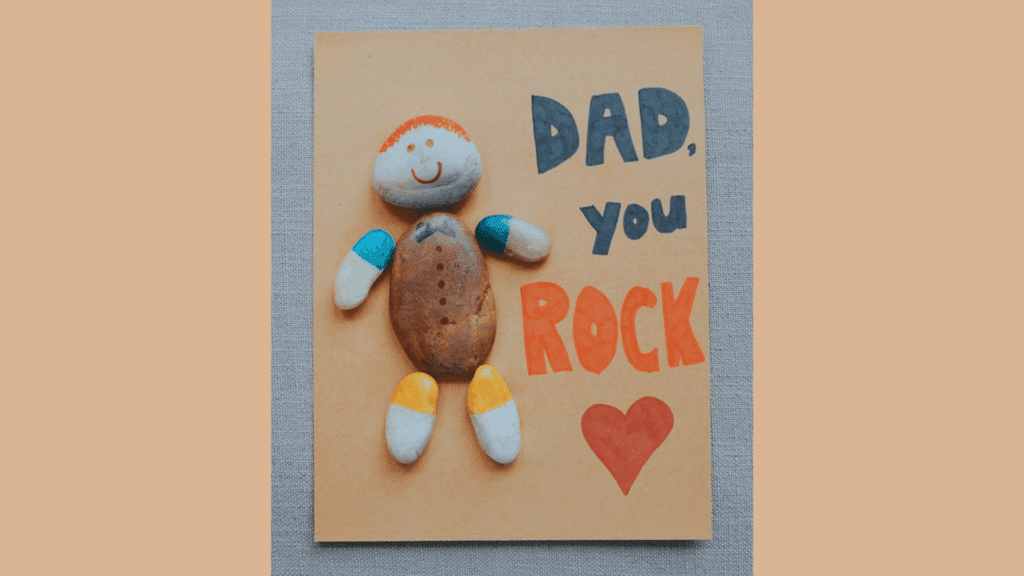 diy valentine gift rock art card with painted rocks and message dad you rock on brown paper (1)