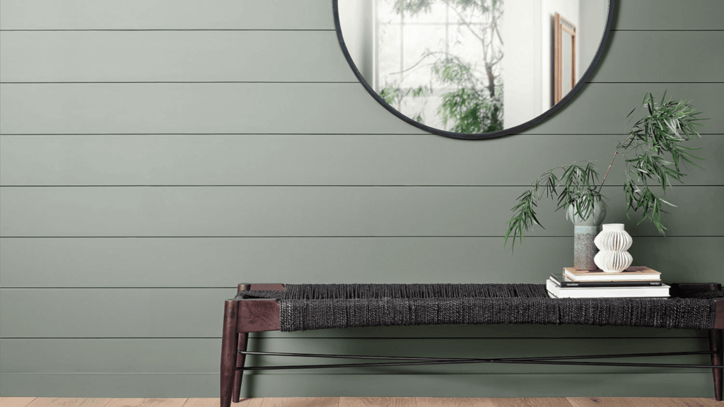 entryway interior with bench mirror and decor with wall painted in sherwin williams pewter green and light wood floor