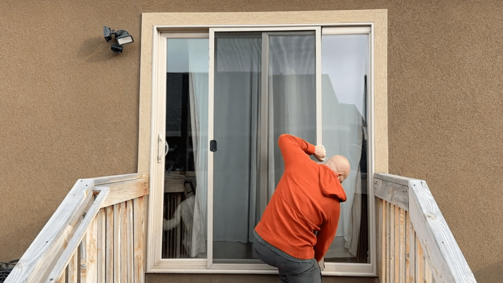 finish securing bottom edge then trim excess mesh neatly and reinstall handle to complete screen door assembly