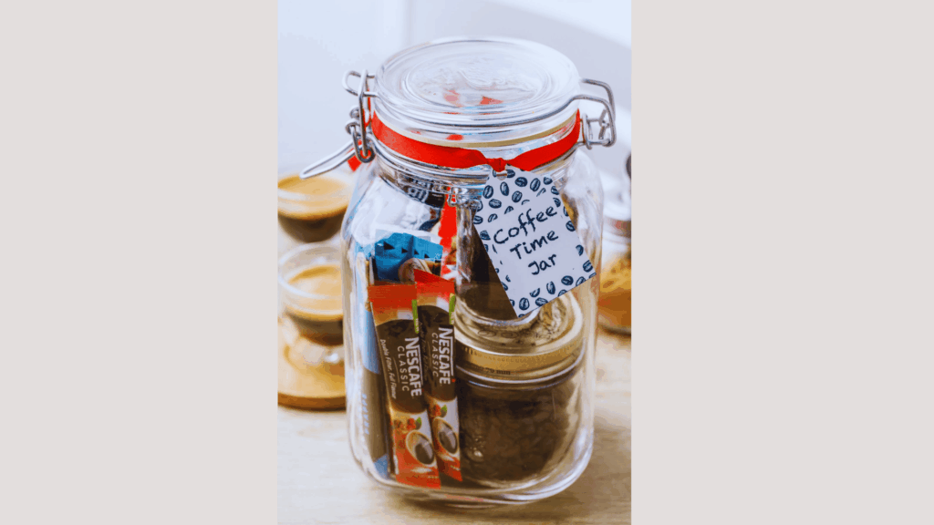 glass jar labeled coffee time jar filled with coffee packets and beans tied with a red ribbon