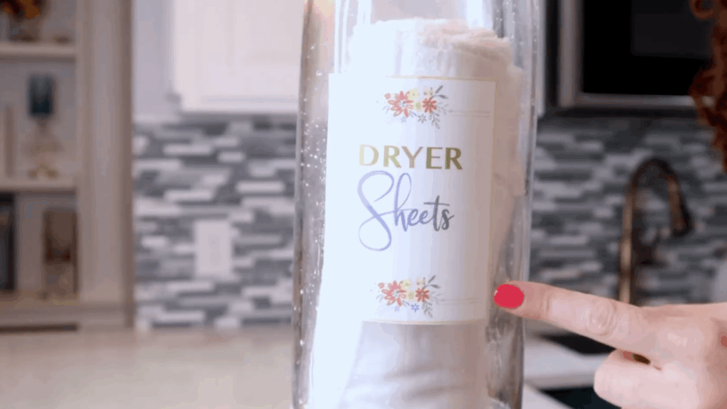 glass jar with homemade dryer sheets stored airtight to keep them moist and ready for reuse