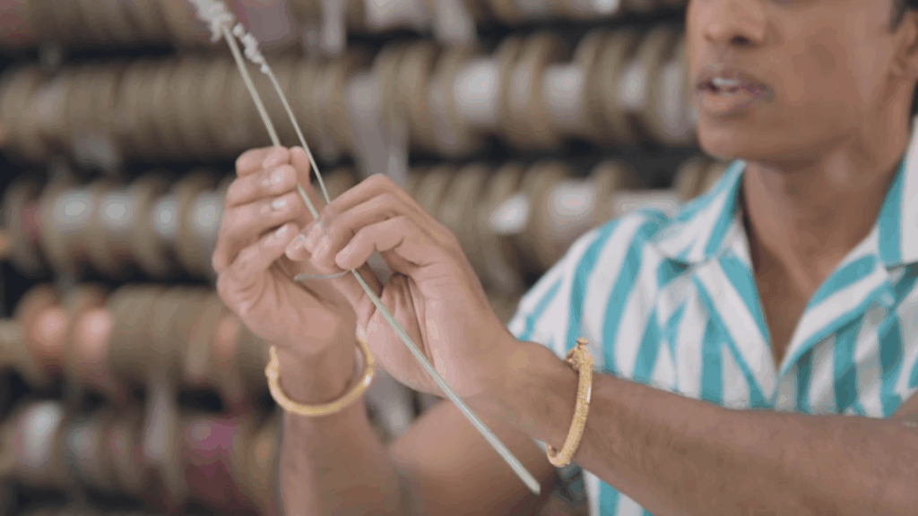 hands examining single lavender stem during bouquet making