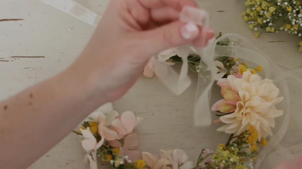 how to make a flower crown by adding a ribbon to secure the crown and tie it at the back