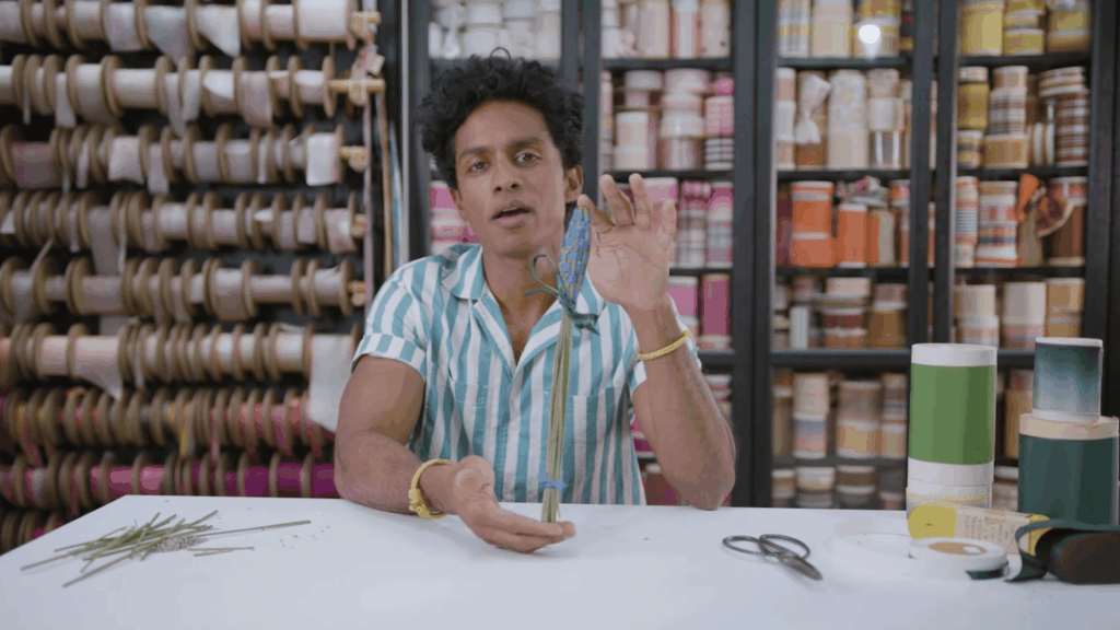 lavender bouquet wrapped in purple ribbon resting on fabric