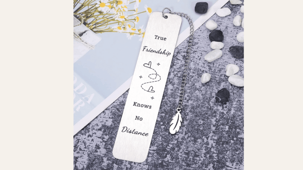 metal bookmark with the quote true friendship knows no distance and a feather charm