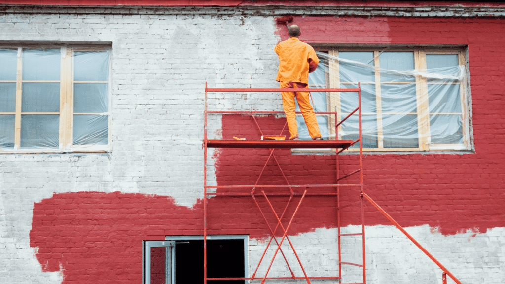 painter applying exterior paint in suitable weather conditions showing best temperature to paint outside