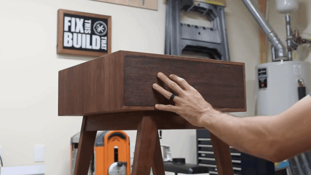 person building drawer and attaching front panel on wooden box in workshop for diy end table (1)