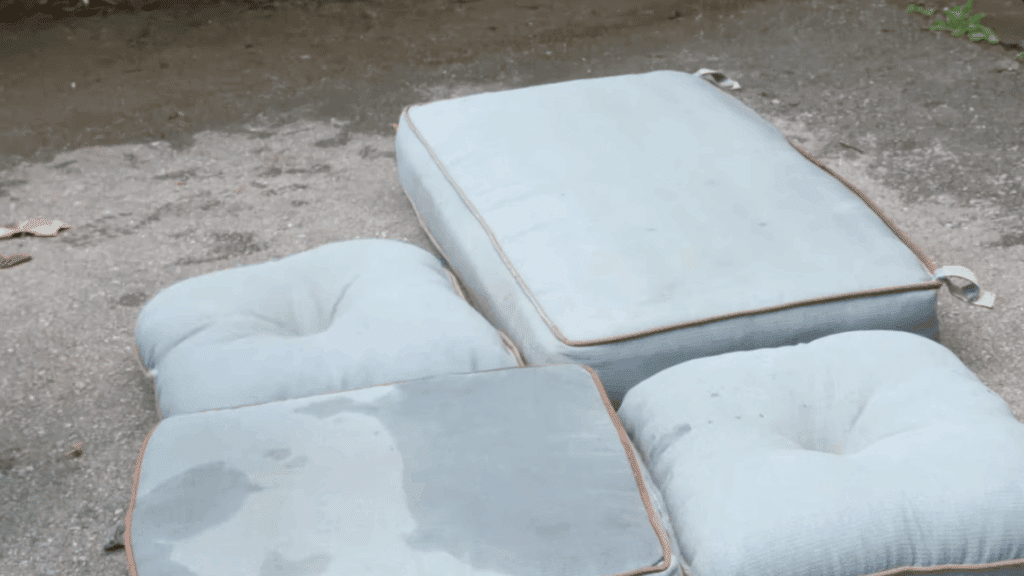 placing outdoor cushions on a clean dry surface like a driveway deck or sidewalk for easy cleaning
