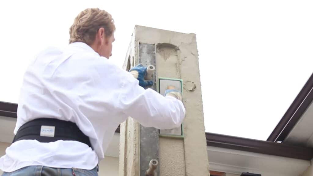 repairing uneven stucco corner using straight edge to create clean edge