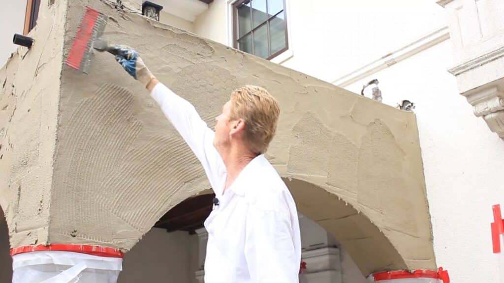 scratching fresh stucco base coat with cross pattern for better bonding