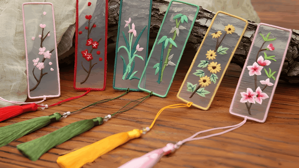 set of embroidered floral bookmarks with colorful tassels displayed on wooden table for homemade gifts made easy