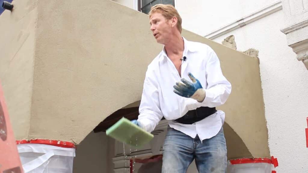 sponge floating stucco with water to bring sand aggregate to surface