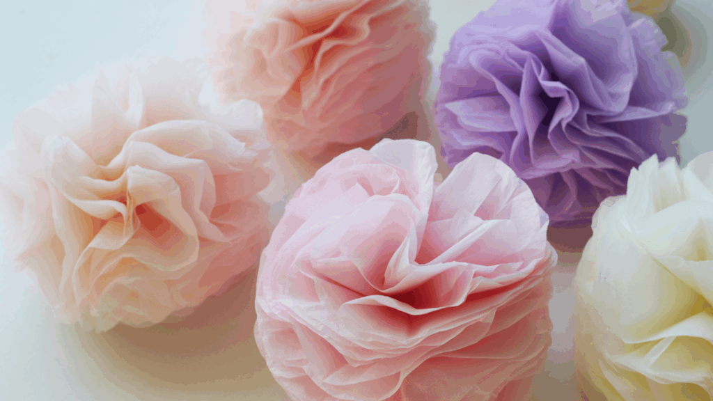 tissue paper pom pom flowers in soft colors showcasing easy flower crafts for any occasion