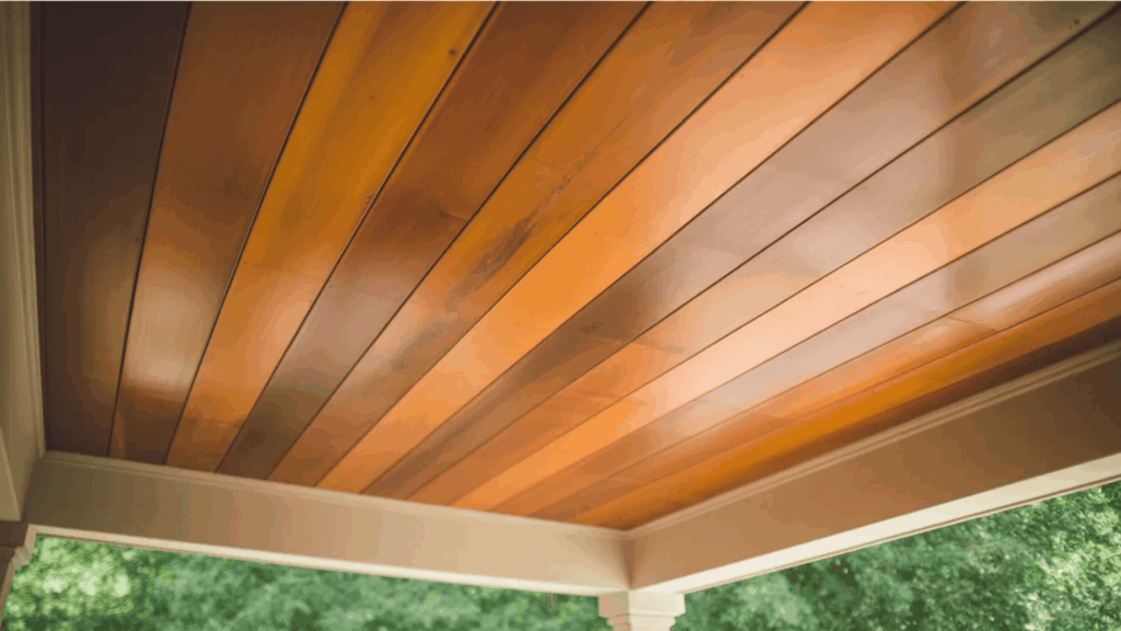 warm wood tones on porch ceiling with large panels porch ceiling ideas