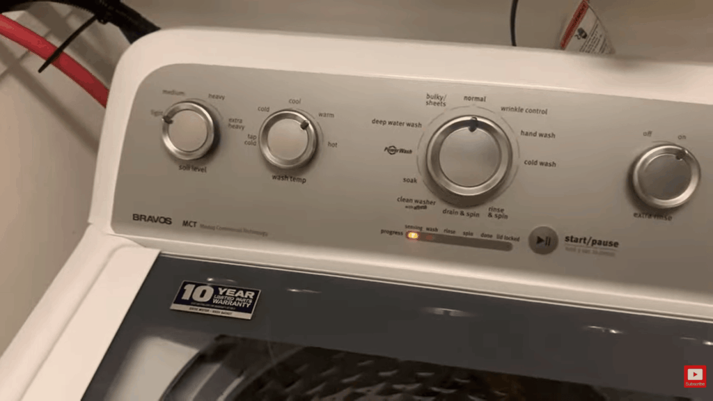 washing machine control panel set for hot wash cycle to remove mold from fabric with knobs and start button active indicator light