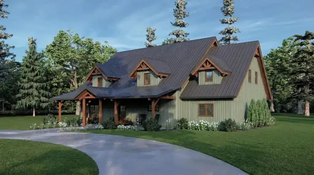 A saltbox house with light green siding, a dark metal roof, and three dormer windows set against a forest.