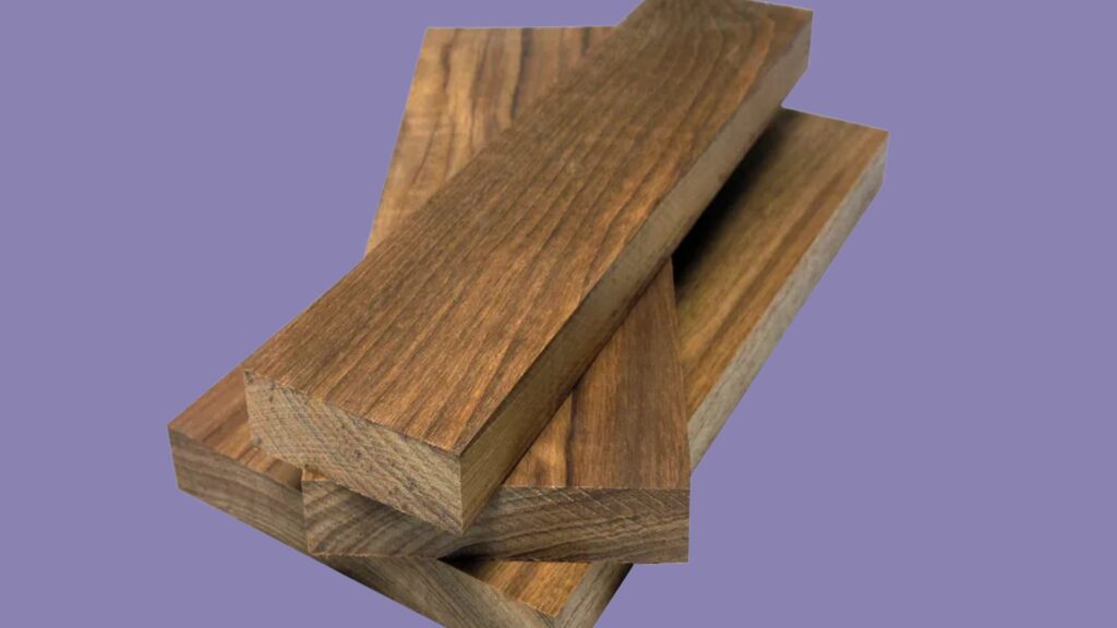 Close-up of teak wood planks stacked on top of each other against a purple background.