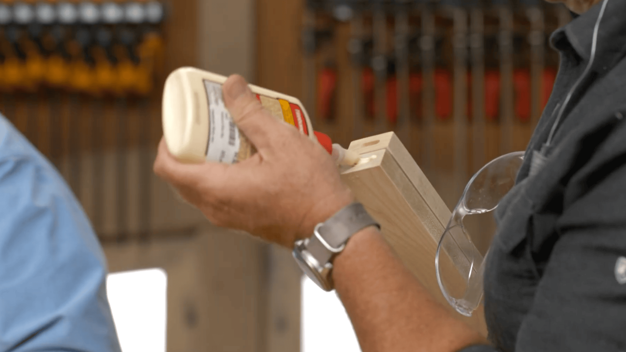 applying glue on wood pieces to form strong pole for diy clothes rack with secure joint and smooth finish