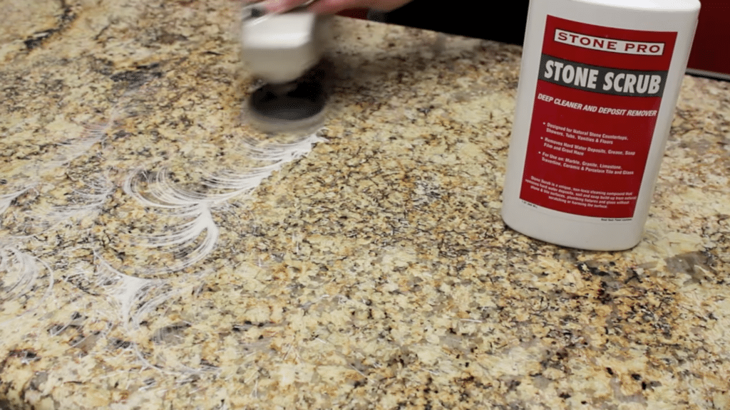 applying stone scrub with a polisher as part of how to polish granite countertops for a clean smooth and shiny surface