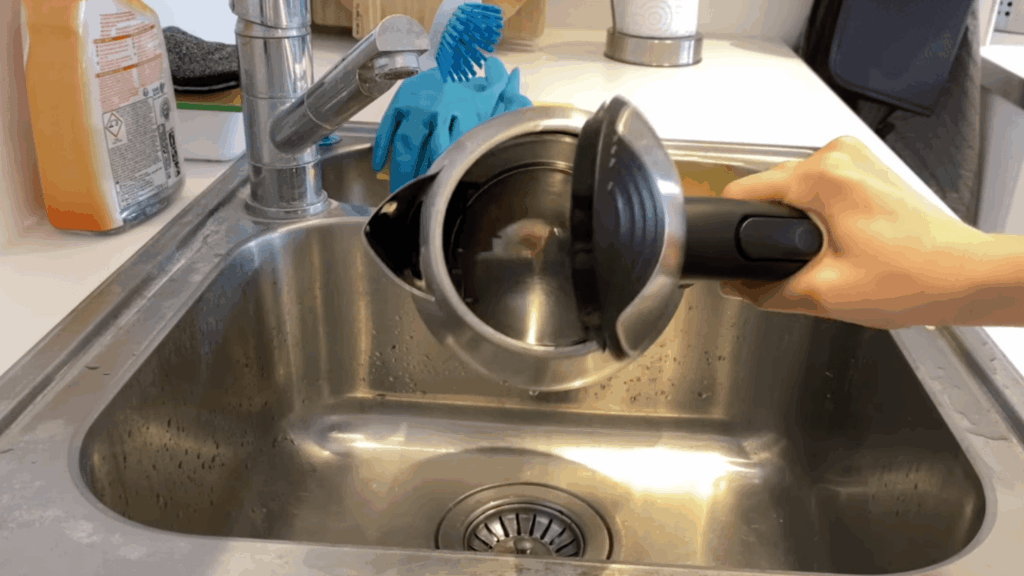 checking inside electric kettle and repeating cleaning or scrubbing to remove leftover limescale buildup