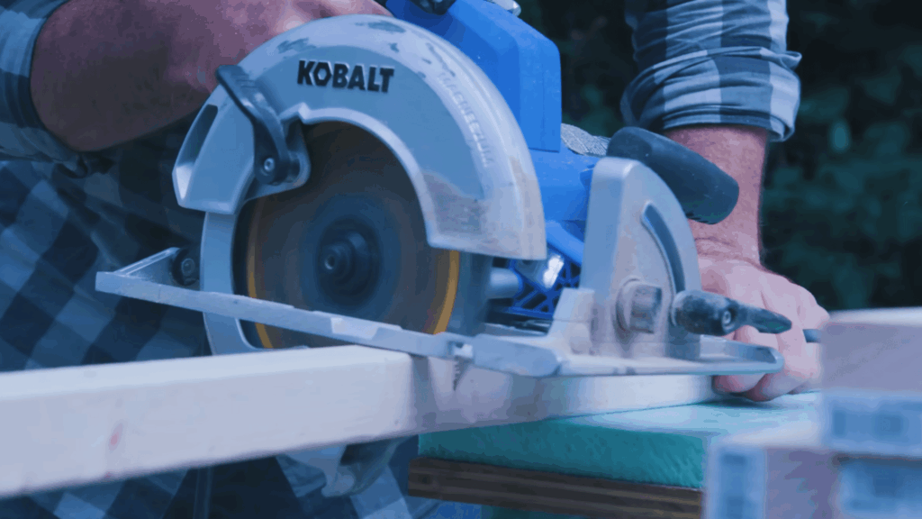 circular saw cutting wooden plank for dog house frame