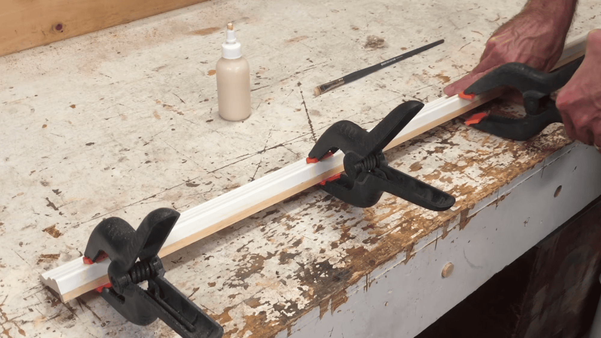 clamping wood strip to trim with glue to add depth for mirror frame before drying and fitting properly