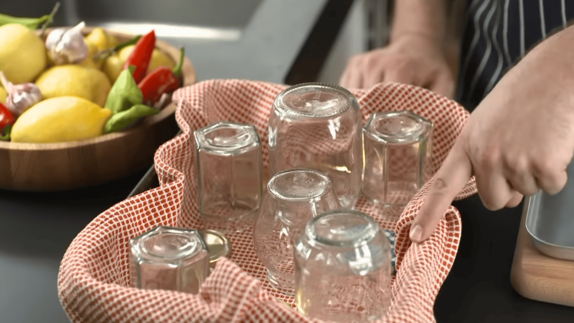 clean glass jars placed upside down on cloth after washing to drain before sterilizing process at home