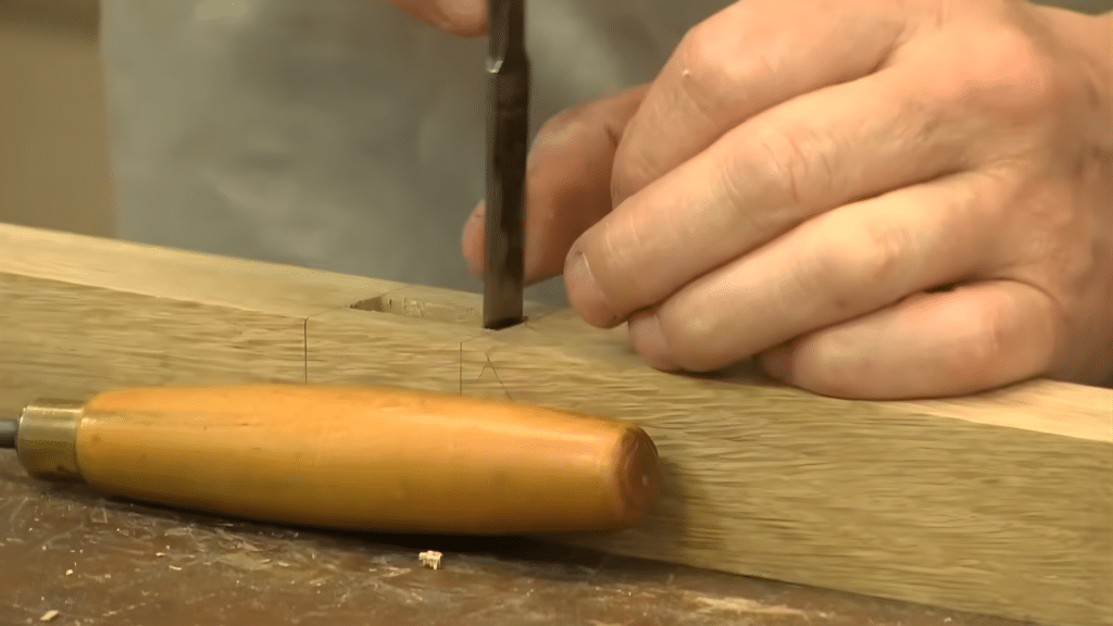 cleaning the mortise walls to ensure sharp smooth edges