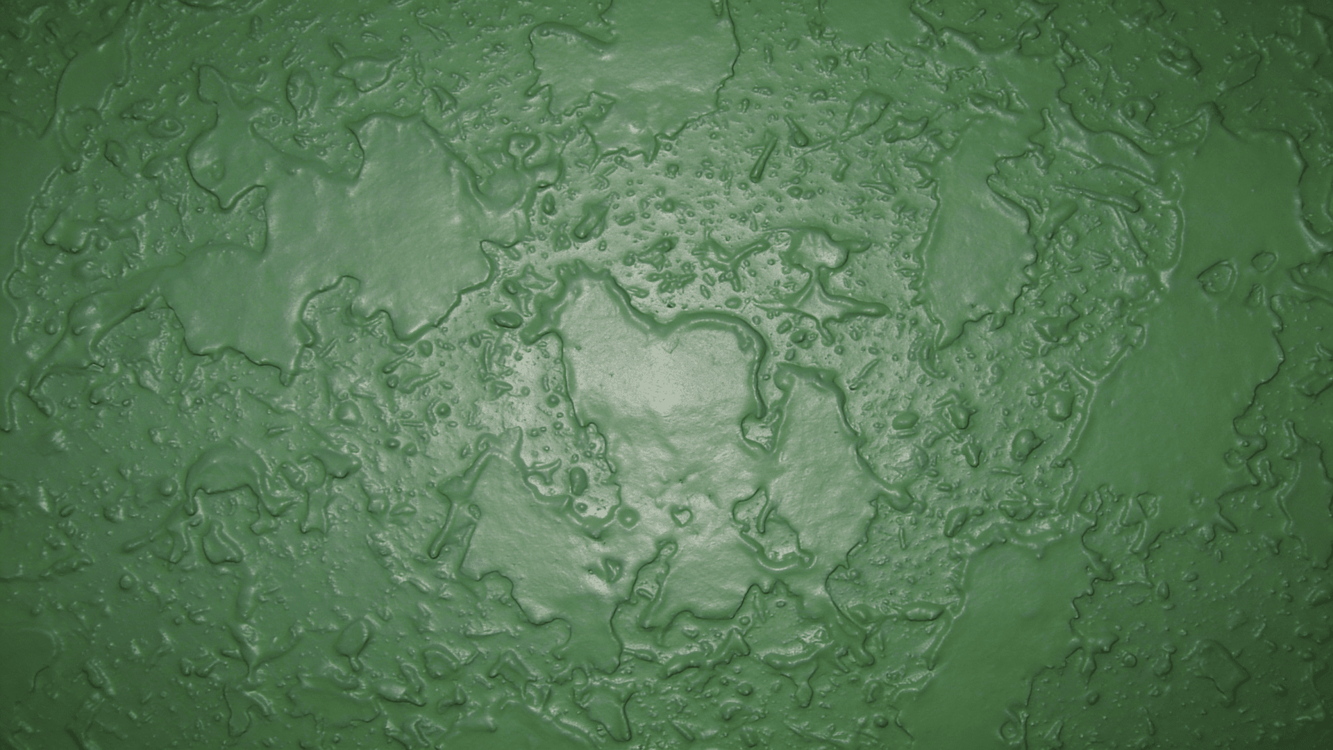 close up of green textured wall with irregular raised patterns and glossy finish creating abstract organic shapes